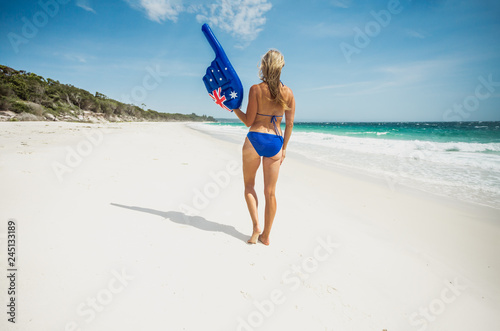 Bikini woman with large pointing finger on the beach in Australia photo