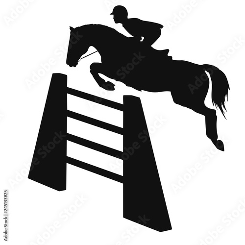 Silhouette of a rider on a horse is jumping over an obstacle.	