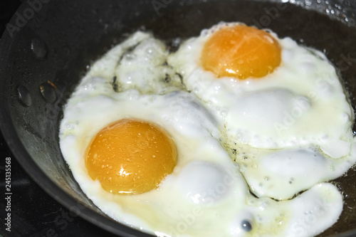 eggs are fried in a frying pan