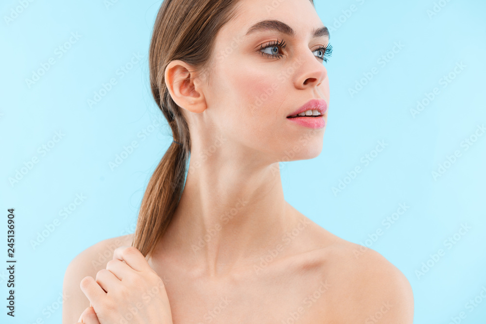 Beautiful young woman posing isolated over blue background. Beautiful young woman posing isolated over blue background.