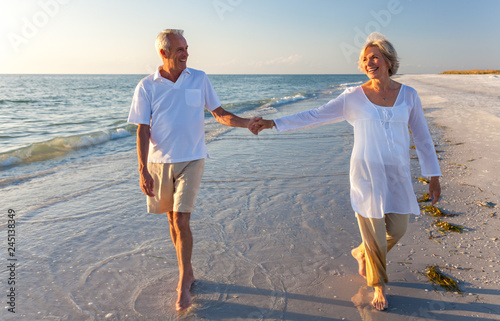 Happy Senior Couple Walking Holding Hands Tropical Beach