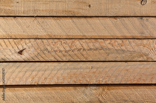 Several rough sawn lumber boards