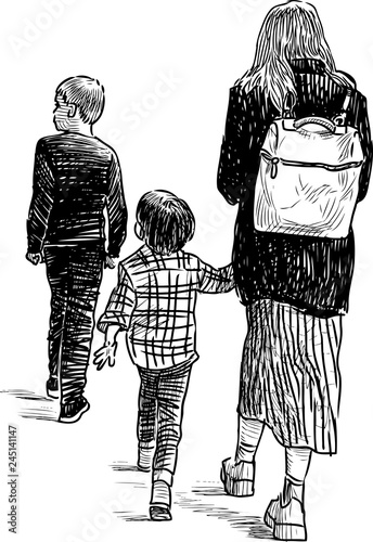A young mother with her kids going on a stroll