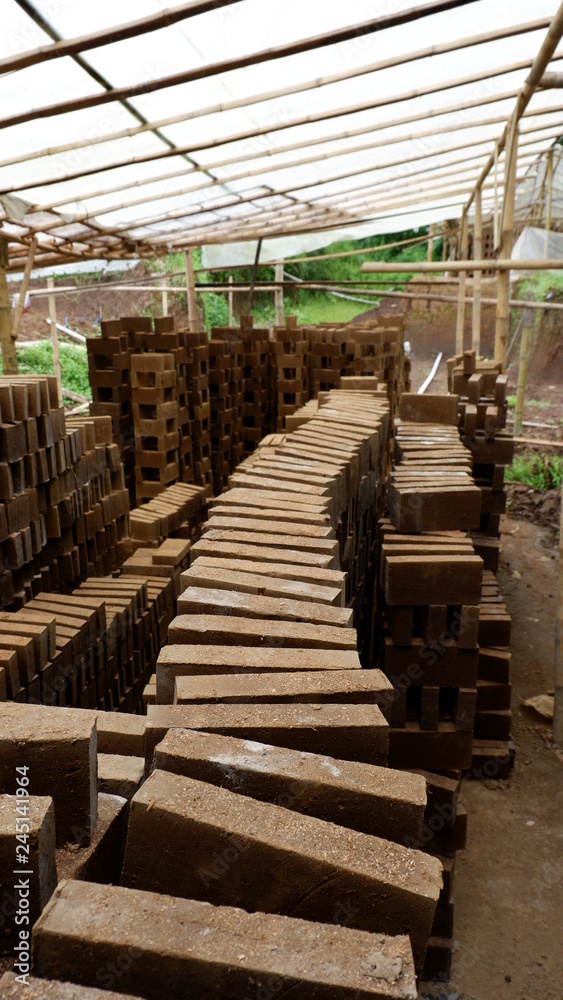 a pile of red bricks ready to be burned