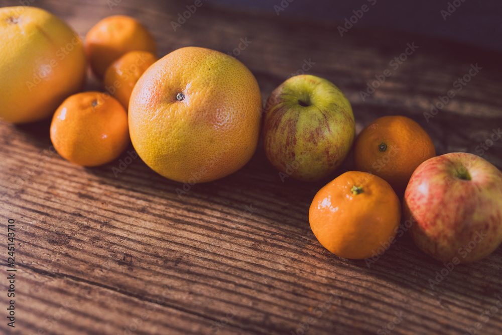 healthy fruit including oranges grapefruit and apples on dark wooden surface with copyspace healthy fruit including oranges grapefruit and apples on dark wooden surface with copyspace