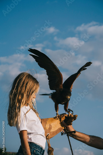 Little Girl with the bird rapacious in her hand