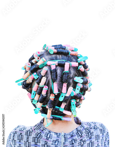 Back head of asian woman curling  and colorful rollers with hair perm solution isolated on white background