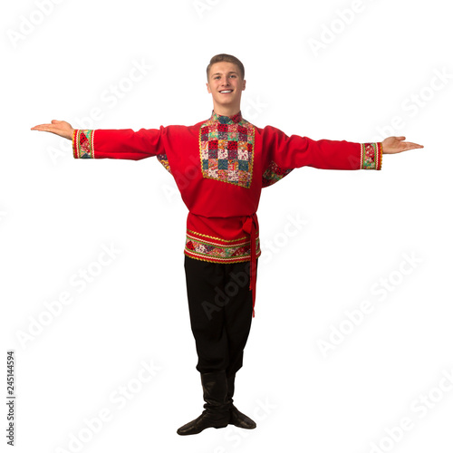 Attractive russian guy dancing in folk costume isolated on white