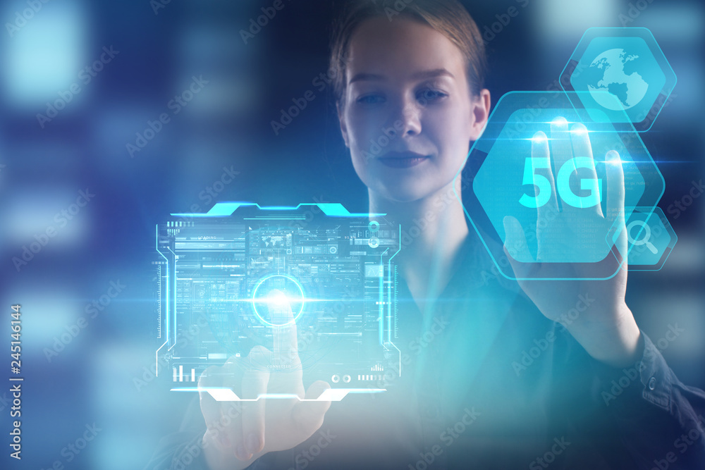 The concept of business, technology, the Internet and the network. A young entrepreneur working on a virtual screen of the future and sees the inscription: 5G The concept of business, technology, the Internet and the network. A young entrepreneur working on a virtual screen of the future and sees the inscription: 5G