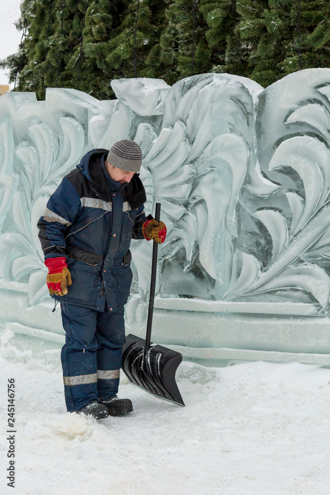 Assembler in overalls on the territory of the ice town Assembler in overalls on the territory of the ice town