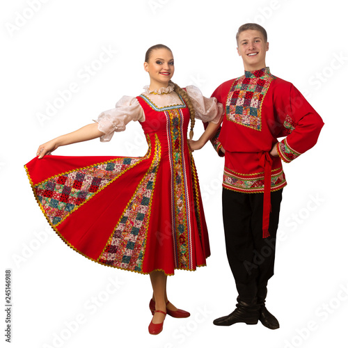 Beautiful caucasian couple dancing in Russian folk costumes isolated on white