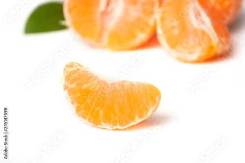 pieces of peeled tangerine on white background