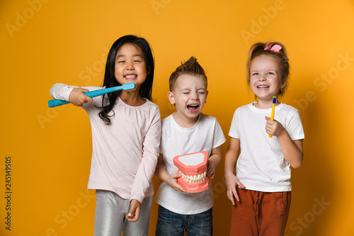 dental hygiene. happy little cute children with toothbrushes.