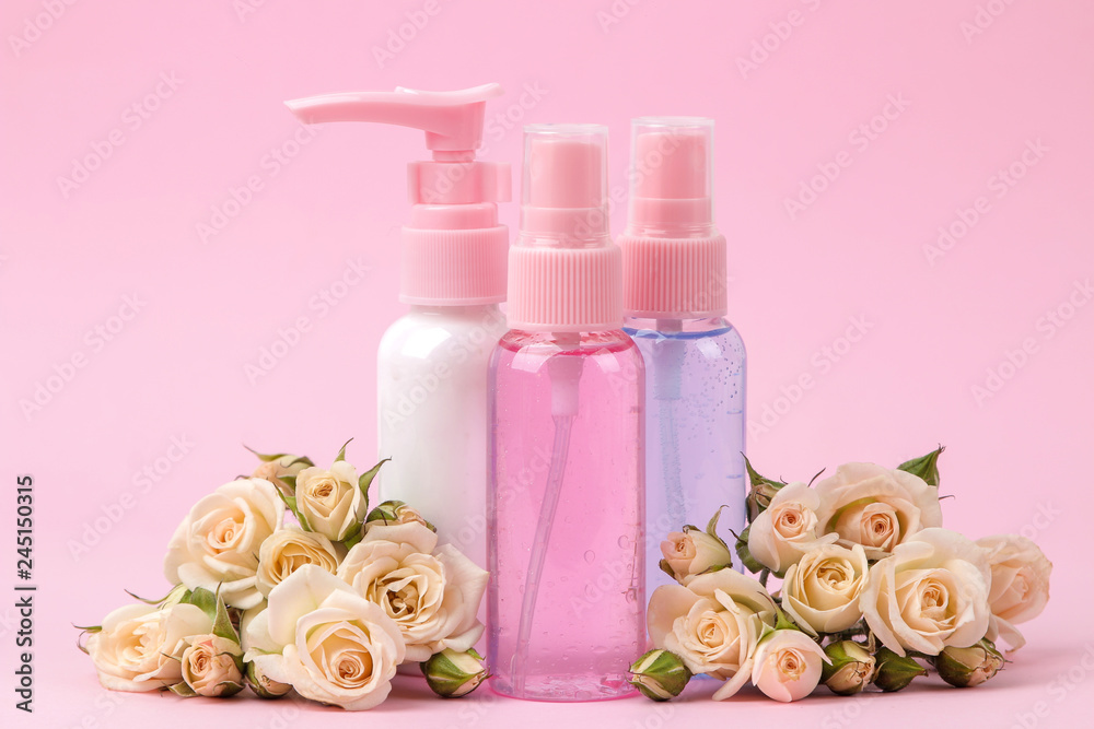 cosmetics for face and body in pink bottles with fresh roses on a delicate pink background. cream and lotion. spa. cosmetics for face and body in pink bottles with fresh roses on a delicate pink background. cream and lotion. spa.