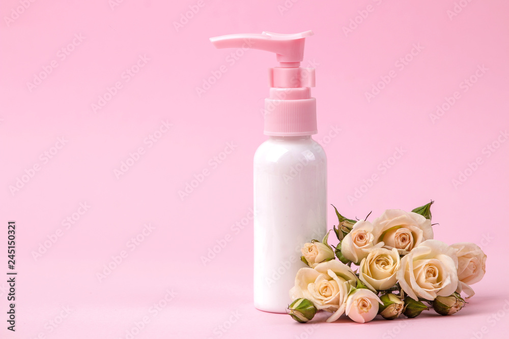 cosmetics for face and body in pink bottles with fresh roses on a delicate pink background. spa. view from above. space for text cosmetics for face and body in pink bottles with fresh roses on a delicate pink background. spa. view from above. space for text