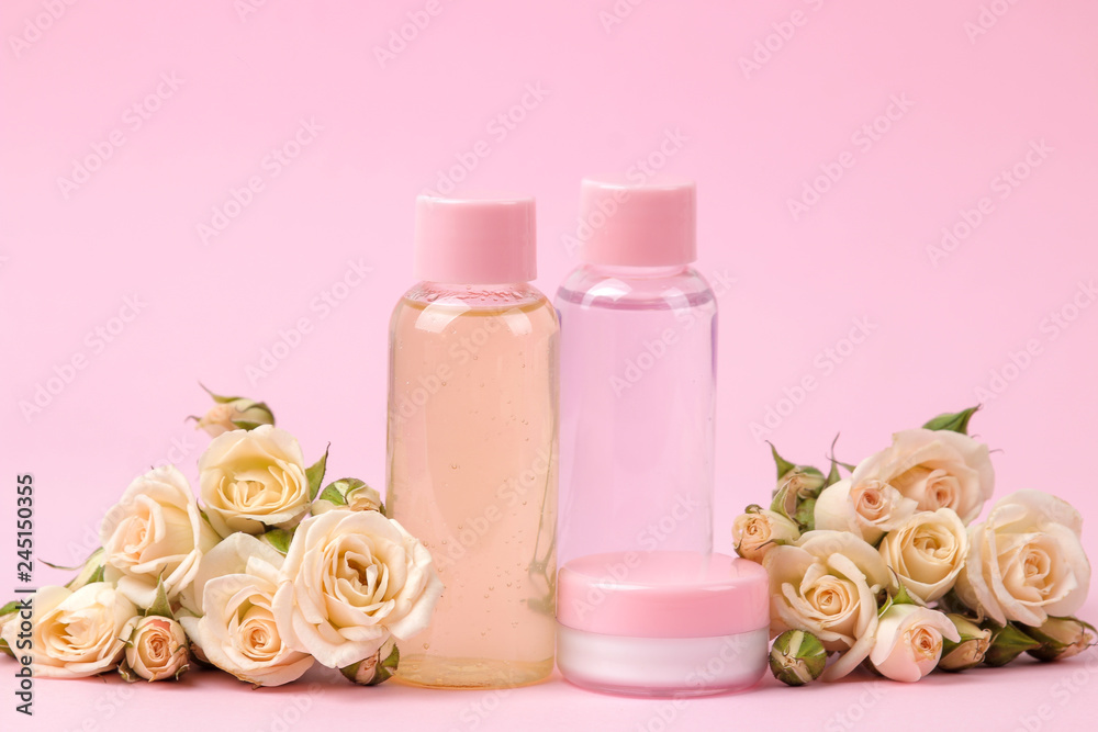 cosmetics for face and body in pink bottles with fresh roses on a delicate pink background. cream and lotion. spa. cosmetics for face and body in pink bottles with fresh roses on a delicate pink background. cream and lotion. spa.
