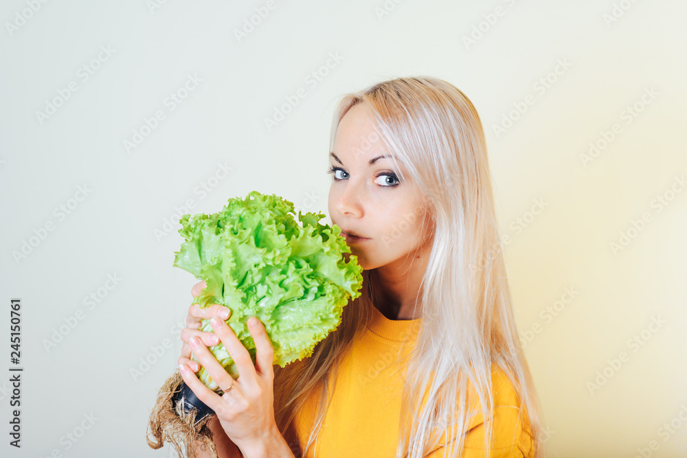 Portrait of an attractive girl with a salad Bush. Dieting concept.