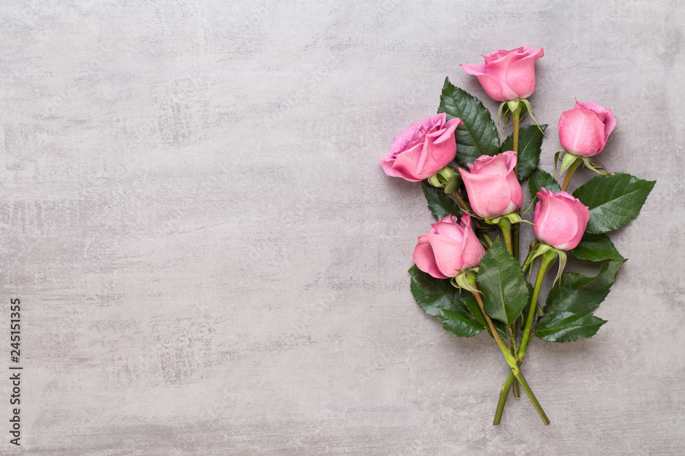 Flowers valentine day composition. Frame made of pink rose on gray background. Flat lay, top view, copy space. Flowers valentine day composition. Frame made of pink rose on gray background. Flat lay, top view, copy space.