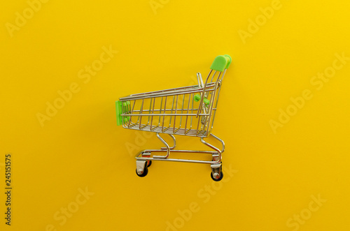 empty shopping cart on yellow background