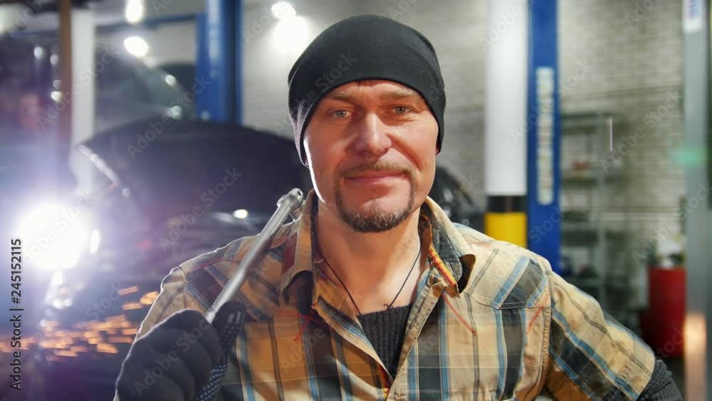 Car service. Mechanic man standing by the car Car service. Mechanic man standing by the car