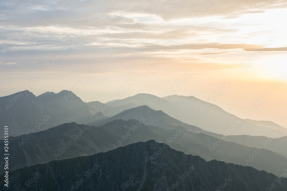 Panoramic view over layers of mountain ridges in the sunset light