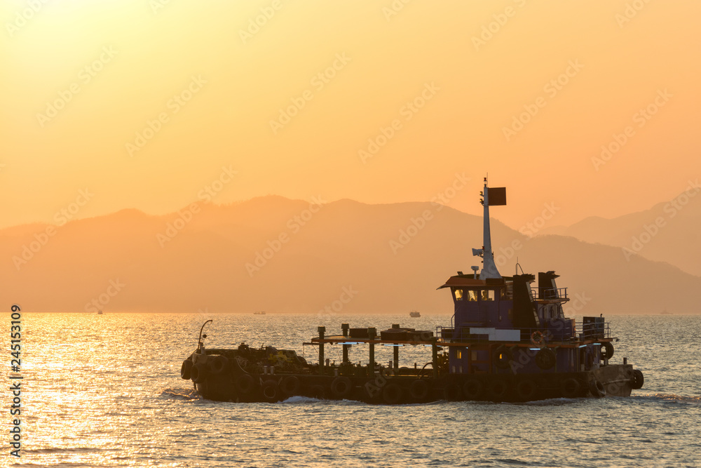 Fishing ship on the water in the sunset. Hong Kong, Asia