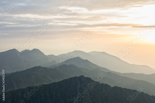 Panoramic view over layers of mountain ridges in the sunset light