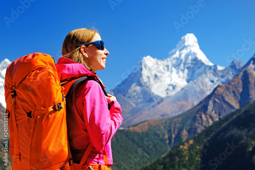 Hikers with backpacks reaches the summit of mountain peak. Success freedom and happiness achievement in mountains. Active sport concept.