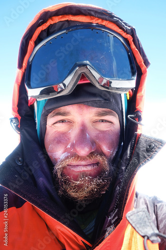 Climber reaches the summit of mountain peak. Success, freedom and happiness, achievement in mountains. Climbing sport concept.