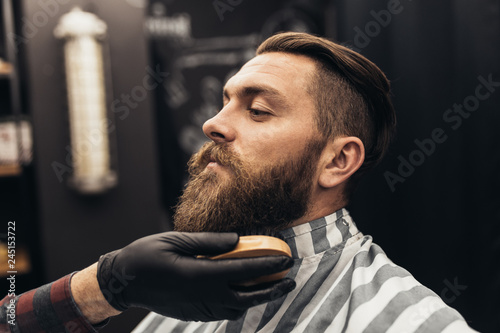 Quadro su tela Hipster young good looking man visiting barber shop