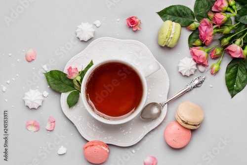 Black tea on the white cup with macaroons