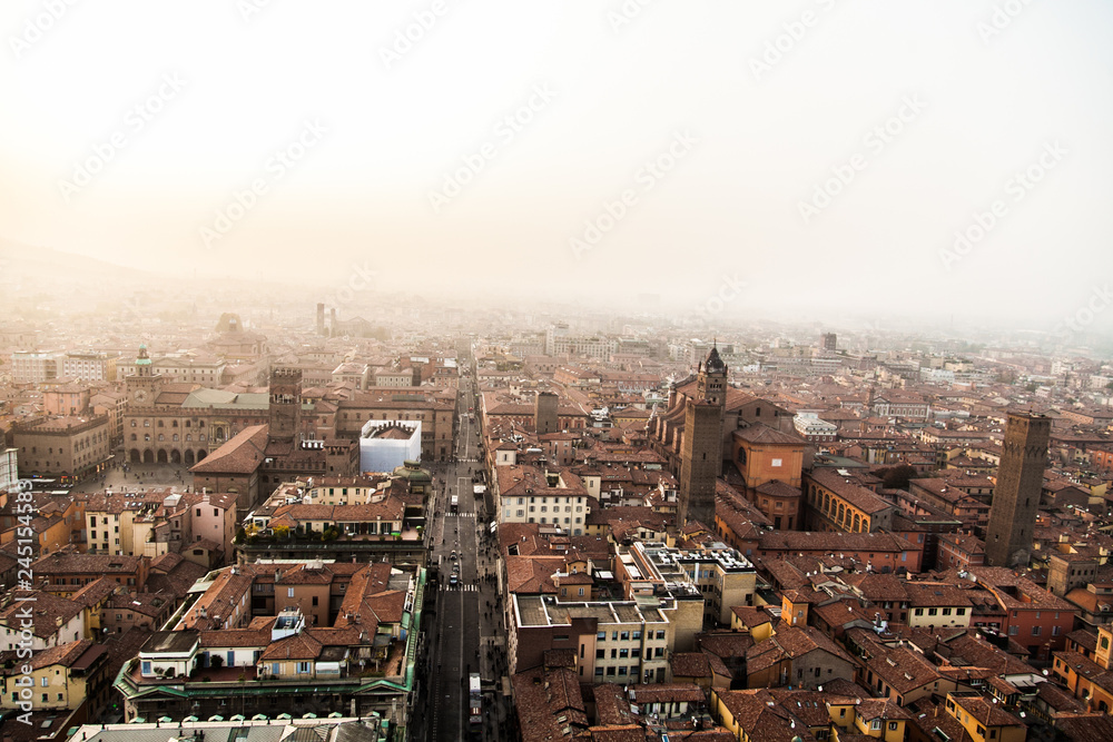 Aerial panoramic cityscape of Bologna, Italy, above rooftops of typical houses, ancient buildings and medieval towers 