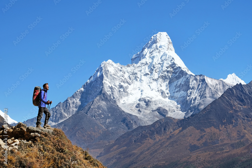 Hiker with backpacks in Nepal. Success freedom and happiness achievement in mountains. Active sport concept.