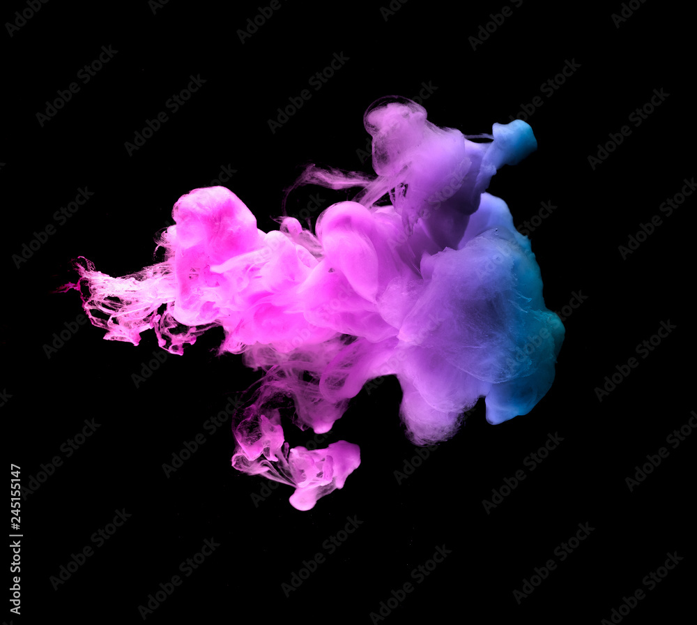 colored acrylic paint in water. the explosion of colours on a black background