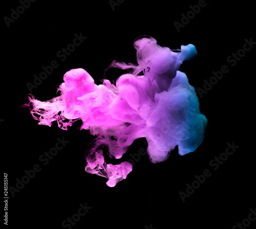 colored acrylic paint in water. the explosion of colours on a black background