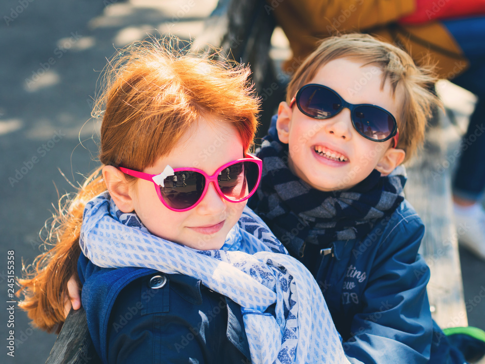 Two cute kids, siblings hugging outdoors Two cute kids, siblings hugging outdoors