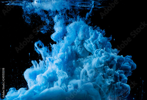 colored acrylic paint in water. the explosion of colours on a black background