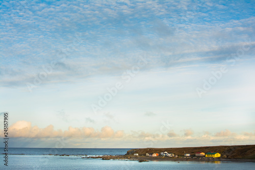 Wallpaper Mural Colorful remote village on the ocean in Newfoundland featured amid early morning blue skies Torontodigital.ca