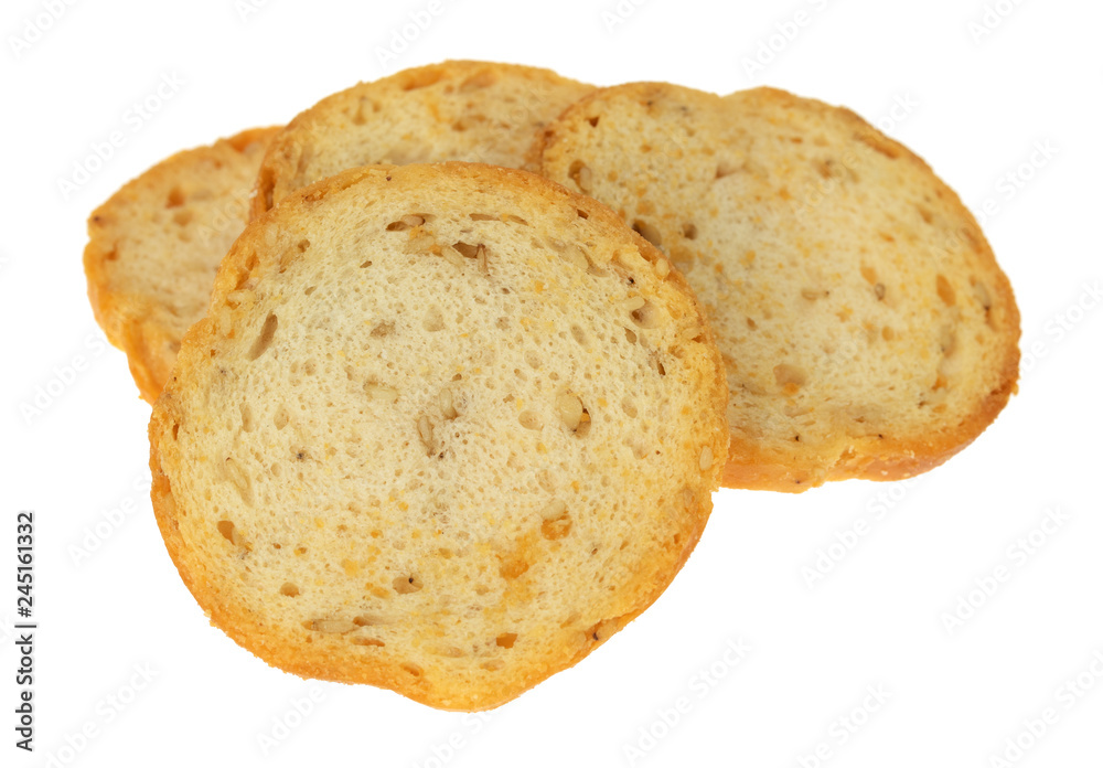 Side view of four pieces of sesame round melba toast isolated on a white background.
