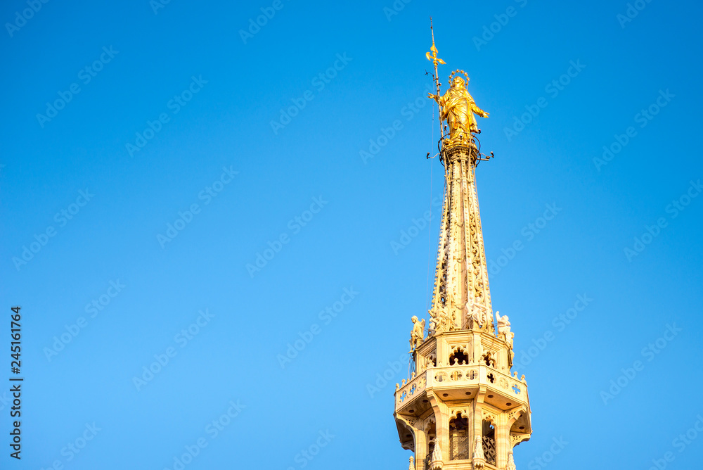 Milan Duomo golden Madonnina detail in a sunny day and blue sky Italian travel destinations Milan city italy Milan Duomo golden Madonnina detail in a sunny day and blue sky Italian travel destinations Milan city italy