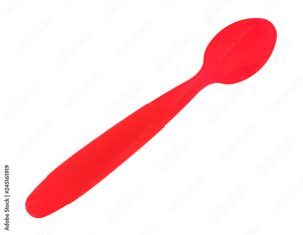 Red plastic baby food spoon isolated on a white background. Red plastic baby food spoon isolated on a white background.