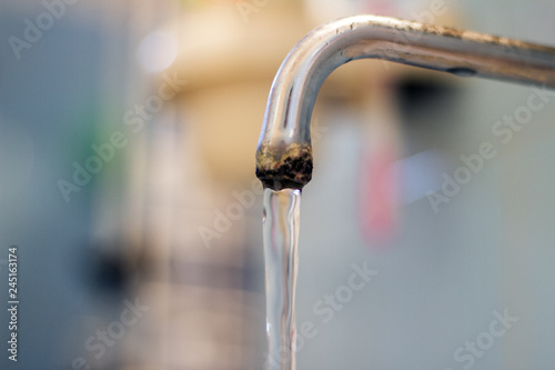 old faucet and water flow on bathroom