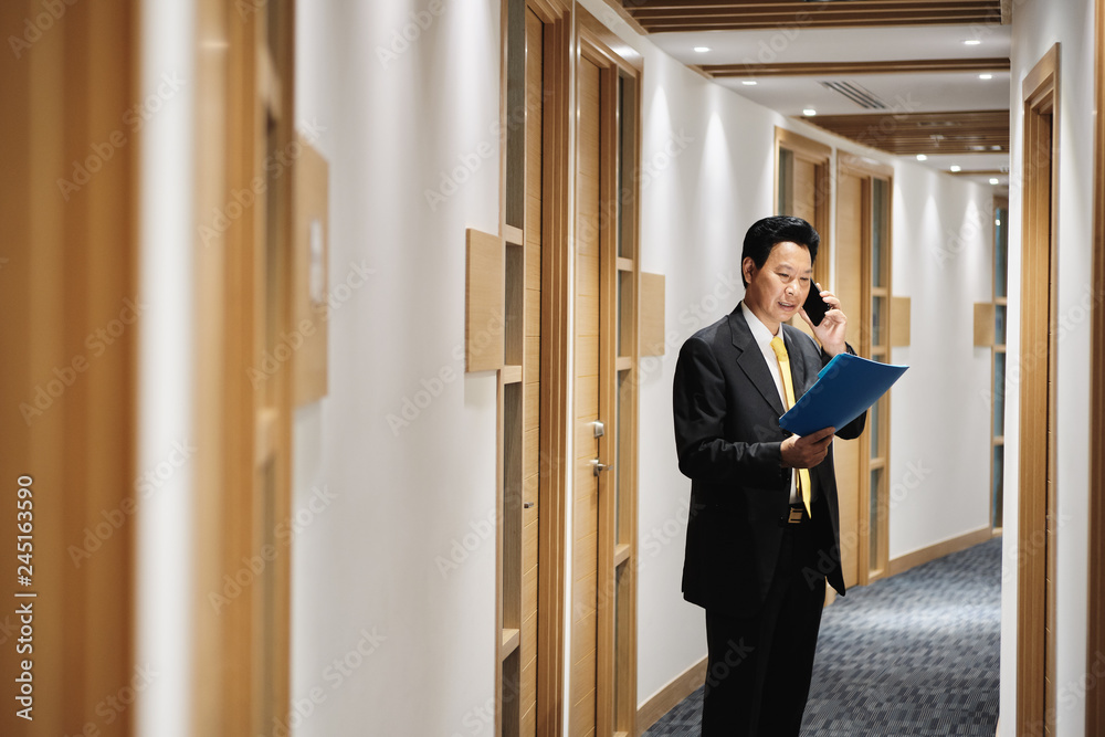 Asian Manager Working As Banking Agent Talking On Cell Phone Asian Manager Working As Banking Agent Talking On Cell Phone