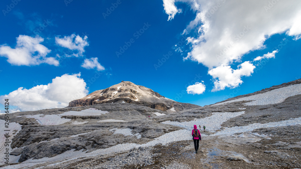 Tourists going to Piz Boe peak, 3152 m, in Sella massif, Dolomiti, Italy. View of rocky landscape from the hiking path.
