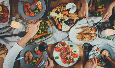 Top view image of family celebrating birthday, happy friends dinning together at home enjoying homemade healthy food, holidays and toasting concept