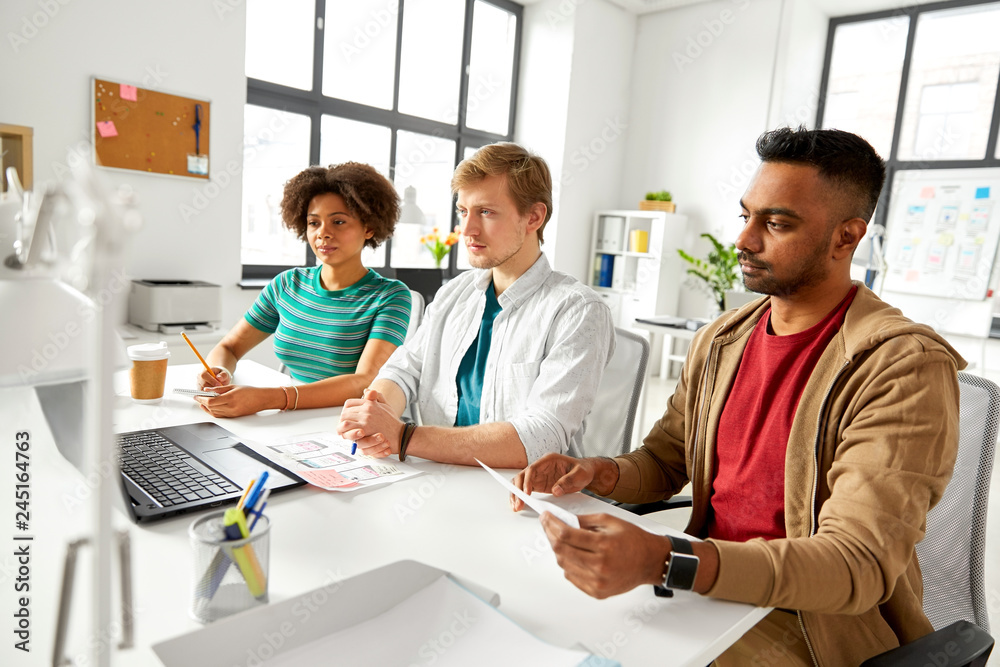 Obraz premium business and people concept - happy creative workers with laptop computers working at office