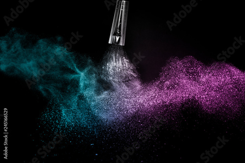 Fototapeta Naklejka Na Ścianę i Meble -  Cosmetic brush with Deep ocean  cosmetic powder spreading for makeup artist or graphic design in black background