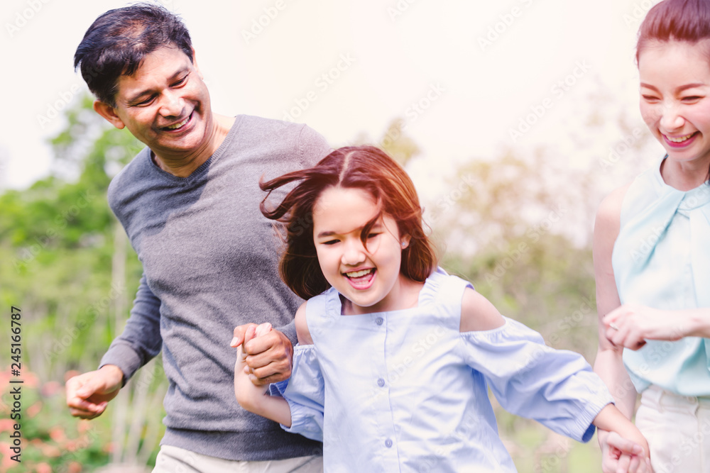 Cheerful family having picnic relaxing together on green nature in park Cheerful family having picnic relaxing together on green nature in park