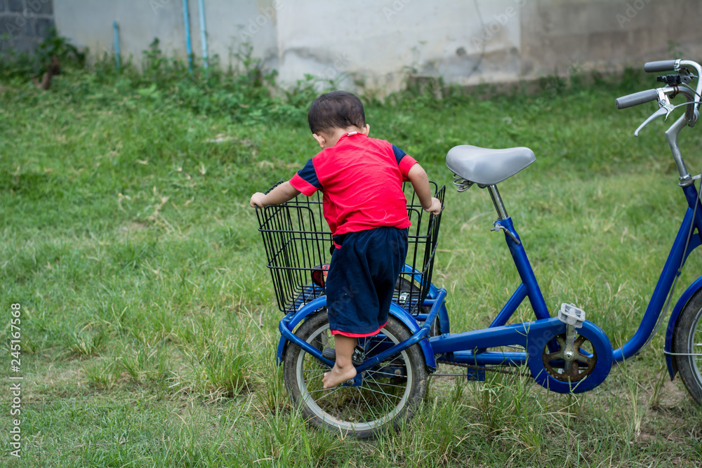 Happy children playing with a bike alone. Happy children playing with a bike alone.