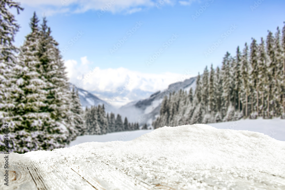 Table background of free space and winter landscape of trees and mountains. 